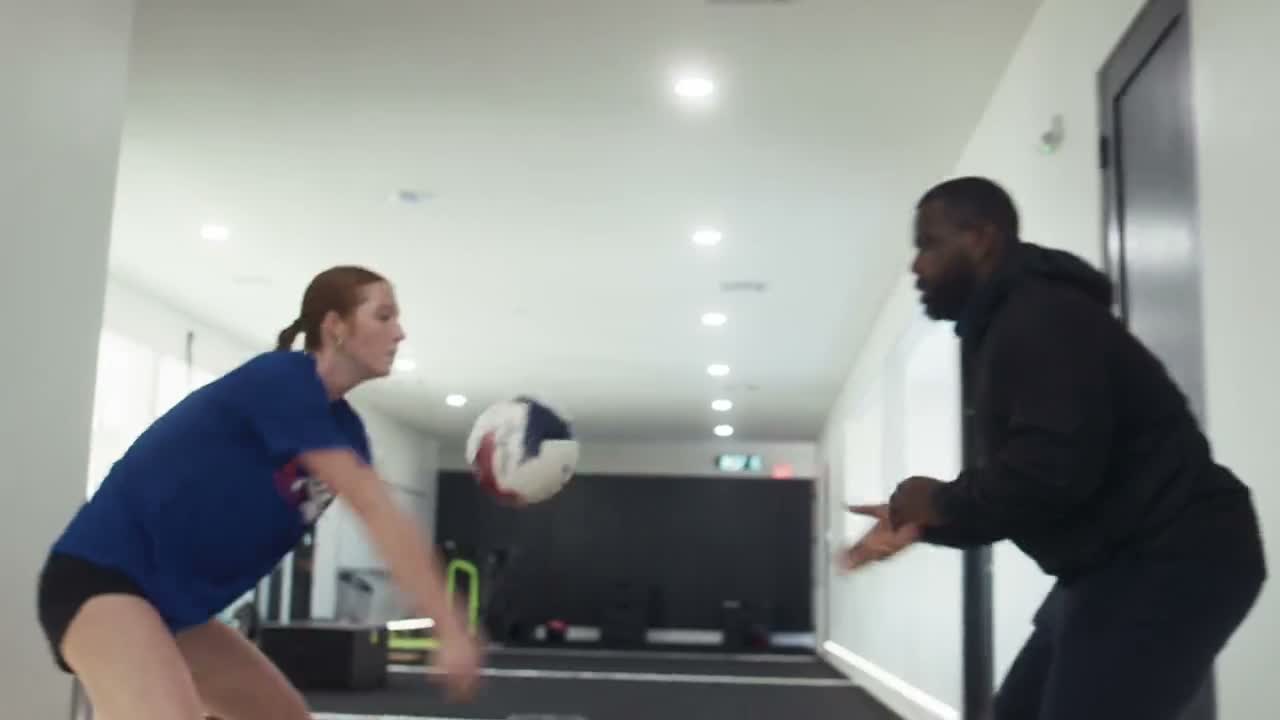 A NeoFit coach running a sport-specific performance drill with an athlete